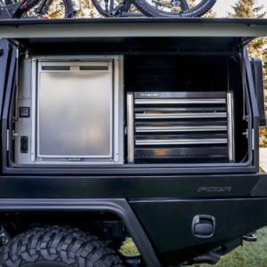 On the driver’s-side of the PCOR storage system of the Jeep To